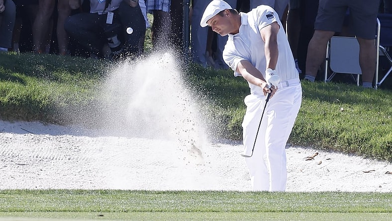 Mar 7, 2021; Orlando, Florida, USA; Bryson DeChambeau hits from a bunker near the fifth green after driving the lake during the final round of the Arnold Palmer Invitational golf tournament at Bay Hill Club & Lodge. Mandatory Credit: Reinhold Matay-USA TODAY Sports