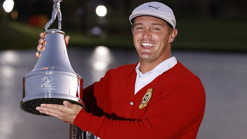 Mar 7, 2021; Orlando, Florida, USA; Bryson DeChambeau holds the champions trophy after winning the Arnold Palmer Invitational golf tournament at Bay Hill Club & Lodge. Mandatory Credit: Reinhold Matay-USA TODAY Sports