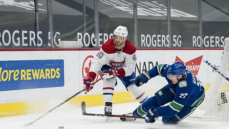 Mar 8, 2021; Vancouver, British Columbia, CAN; Vancouver Canucks defenseman Travis Hamonic (27) checks Montreal Canadiens forward Joel Armia (40) in the second period at Rogers Arena. Mandatory Credit: Bob Frid-USA TODAY Sports