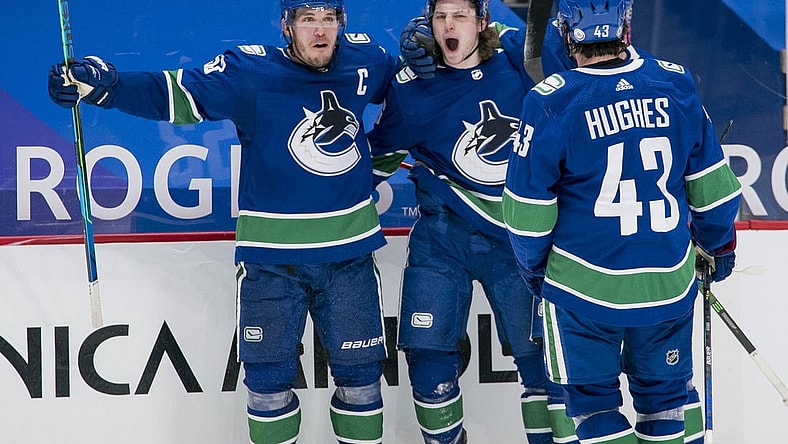 Mar 8, 2021; Vancouver, British Columbia, CAN; Vancouver Canucks forward Bo Horvat (53) and forward Adam Gaudette (96) and  forward J.T. Miller (9) and defenseman Quinn Hughes (43) celebrate Gaudette s goal against the Montreal Canadiens in the third period at Rogers Arena. Canucks won 2-1 in an overtime shootout. Mandatory Credit: Bob Frid-USA TODAY Sports