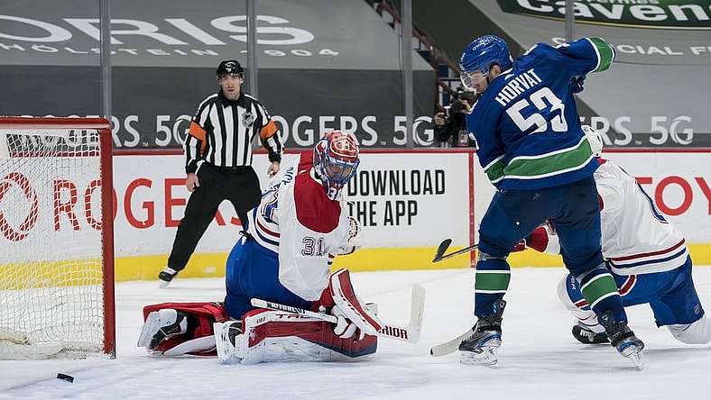 Mar 8, 2021; Vancouver, British Columbia, CAN; Vancouver Canucks forward Bo Horvat (53) and Montreal Canadiens goalie Carey Price (31) watch the rebound in the third period at Rogers Arena. Canucks won 2-1 in an overtime shootout. Mandatory Credit: Bob Frid-USA TODAY Sports