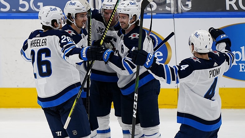 Mar 9, 2021; Toronto, Ontario, CAN; Winnipeg Jets defenseman Josh Morrissey (44) gets congratulated on his goal against the Toronto Maple Leafs during the second period at Scotiabank Arena. Mandatory Credit: John E. Sokolowski-USA TODAY Sports