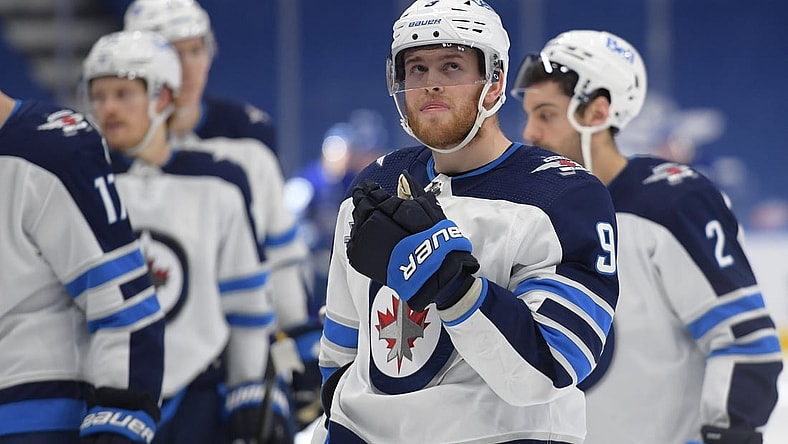 Mar 11, 2021; Toronto, Ontario, CAN;  Winnipeg Jets forward Andrew Copp (9) skates off the ice with teammates after losing 4-3 in overtime to Toronto Maple Leafs at Scotiabank Arena. Mandatory Credit: Dan Hamilton-USA TODAY Sports