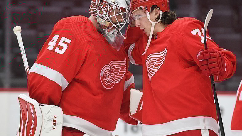 Mar 11, 2021; Detroit, Michigan, USA; Detroit Red Wings goaltender Jonathan Bernier (45) and defenseman Troy Stecher (70) celebrate after the game against the Tampa Bay Lightning at Little Caesars Arena. Mandatory Credit: Tim Fuller-USA TODAY Sports
