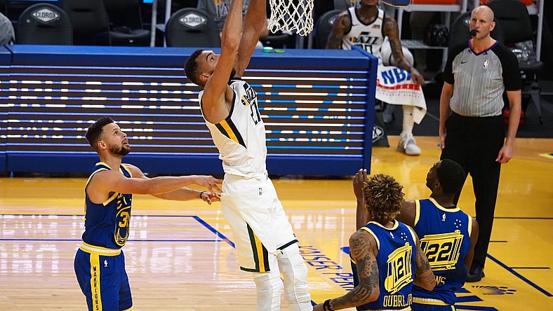 Mar 14, 2021; San Francisco, California, USA; Utah Jazz center Rudy Gobert (27) dunks the ball above Golden State Warriors guard Stephen Curry (30) during the fourth quarter at Chase Center. Mandatory Credit: Kelley L Cox-USA TODAY Sports