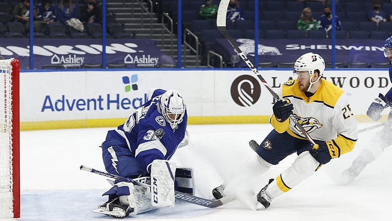 Mar 15, 2021; Tampa, Florida, USA;  Nashville Predators right wing Mathieu Olivier (25) shoots on Tampa Bay Lightning goaltender Curtis McElhinney (35) as he makes a save during the second period at Amalie Arena. Mandatory Credit: Kim Klement-USA TODAY Sports