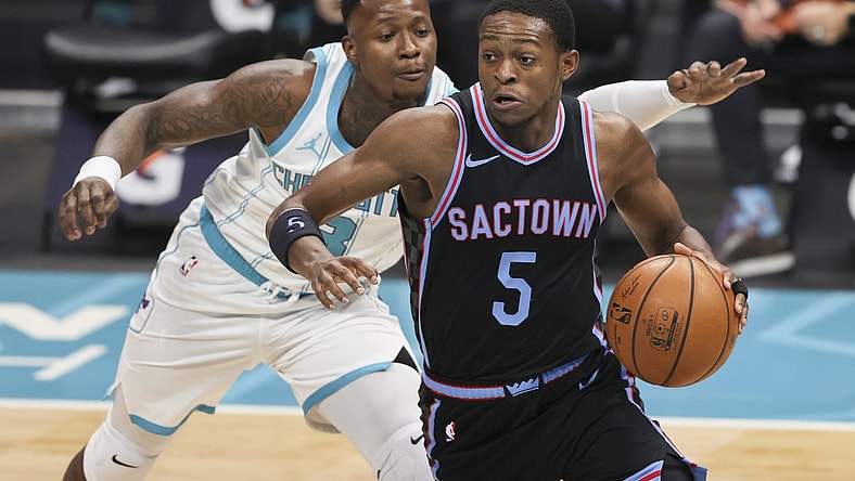 Mar 15, 2021; Charlotte, North Carolina, USA; Sacramento Kings guard De'Aaron Fox (5) drives past Charlotte Hornets guard Terry Rozier (3) during the first quarter at Spectrum Center. Mandatory Credit: Nell Redmond-USA TODAY Sports
