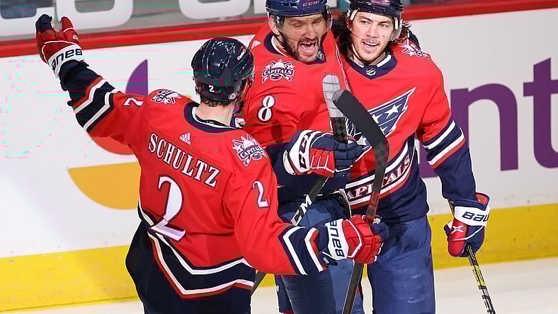 Mar 16, 2021; Washington, District of Columbia, USA; Washington Capitals left wing Alex Ovechkin (8) celebrates with teammates after scoring a goal against the New York Islanders in the second period at Capital One Arena. Ovechkin passed Phil Esposito for sixth all time on the NHL goal scoring list with the goal. Mandatory Credit: Geoff Burke-USA TODAY Sports