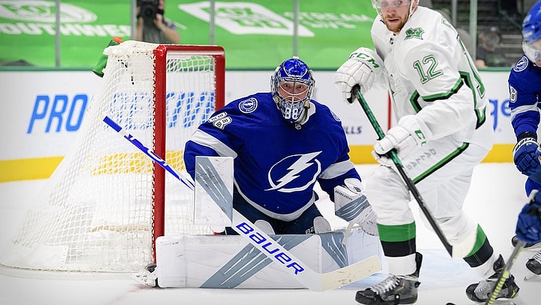 Mar 16, 2021; Dallas, Texas, USA; Tampa Bay Lightning goaltender Andrei Vasilevskiy (88) and Dallas Stars center Radek Faksa (12) look for the puck during the second period at the American Airlines Center. Mandatory Credit: Jerome Miron-USA TODAY Sports