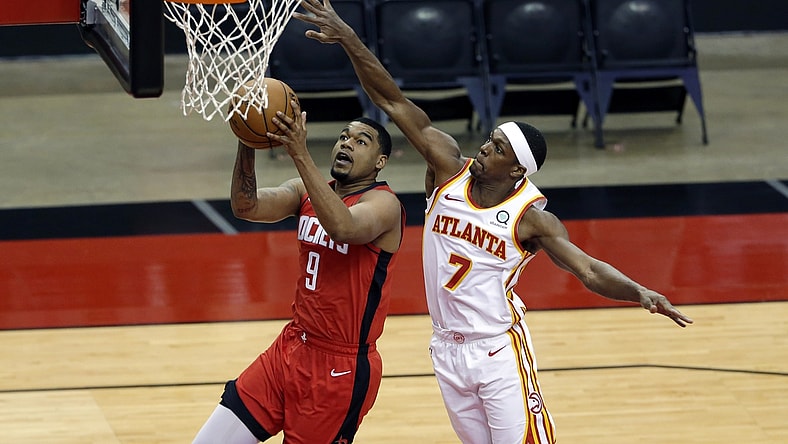 Mar 16, 2021; Houston, Texas, USA; Houston Rockets guard Mason Jones (9) puts up a shot in front of Atlanta Hawks guard Rajon Rondo (7) during the second half at Toyota Center. Mandatory Credit: Michael Wyke/POOL PHOTOS-USA TODAY Sports