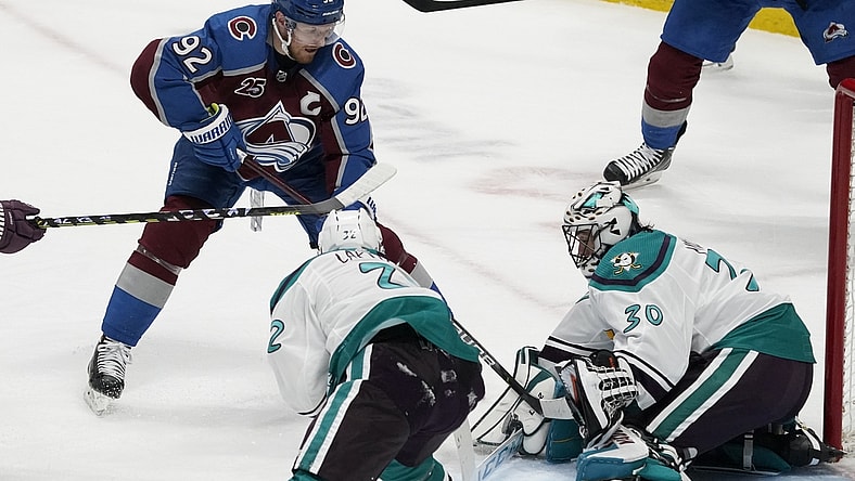 Mar 16, 2021; Denver, Colorado, USA; Colorado Avalanche left wing Gabriel Landeskog (92) shoots the puck against Anaheim Ducks defenseman Jacob Larsson (32) and goaltender Ryan Miller (30) in the second period at Ball Arena. Mandatory Credit: Ron Chenoy-USA TODAY Sports