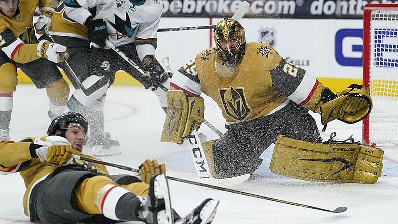 Mar 17, 2021; Las Vegas, Nevada, USA; Vegas Golden Knights defenseman Nicolas Hague (14) slides across the ice after Vegas goaltender Marc-Andre Fleury (29) blocked a shot by the San Jose Sharks during the third period at T-Mobile Arena. Mandatory Credit:  John Locher/POOL PHOTOS-USA TODAY Sports