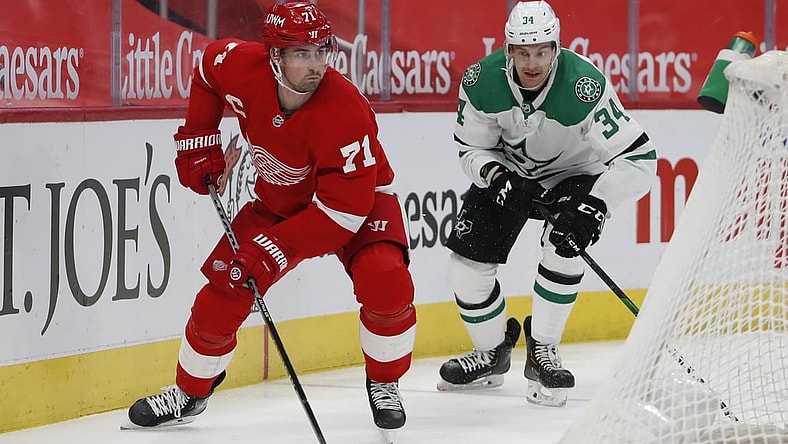 Mar 18, 2021; Detroit, Michigan, USA; Detroit Red Wings center Dylan Larkin (71) skates away from Dallas Stars right wing Denis Gurianov (34) during the first period at Little Caesars Arena. Mandatory Credit: Raj Mehta-USA TODAY Sports