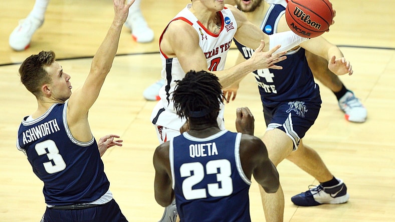 Mar 19, 2021; Bloomington, Indiana, USA; Texas Tech Red Raiders guard Mac McClung (0) moves to the basket against Utah State Aggies guard Steven Ashworth (3) center Neemias Queta (23) and guard Rollie Worster (24) during the first half in the first round of the 2021 NCAA Tournament at Simon Skjodt Assembly Hall. Mandatory Credit: Jordan Prather-USA TODAY Sports