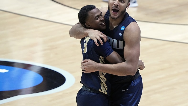 Mar 19, 2021; West Lafayette, Indiana, USA; Oral Roberts Golden Eagles guard Max Abmas (3) and forward Kevin Obanor (0) celebrate after an overtime victory over the Ohio State Buckeyes in the first round of the 2021 NCAA Tournament at Mackey Arena. Mandatory Credit: Mike Dinovo-USA TODAY Sports