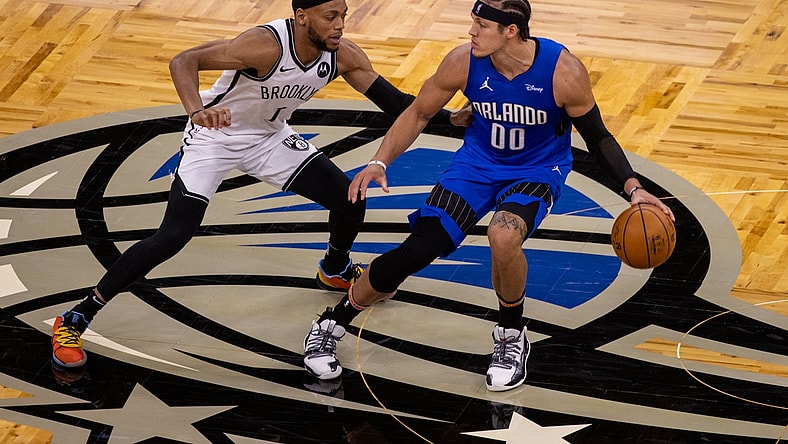 Mar 19, 2021; Orlando, Florida, USA;  Orlando Magic forward Aaron Gordon (00) drives down the court in the second quarter against Brooklyn Nets forward Bruce Brown (1) at Amway Center. Mandatory Credit: Nathan Ray Seebeck-USA TODAY Sports