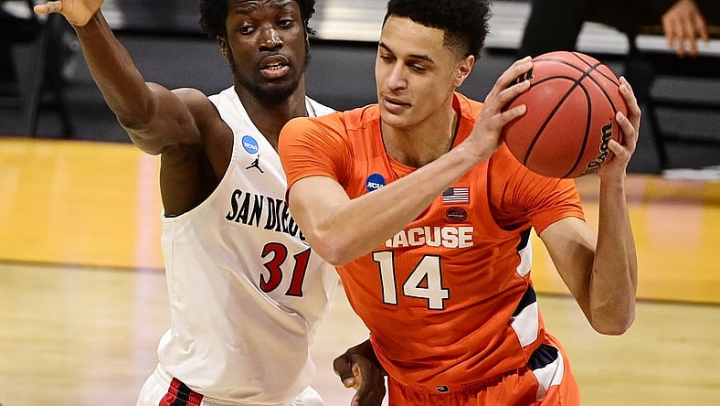 Mar 19, 2021; Indianapolis, Indiana, USA; Syracuse Orange center Jesse Edwards (14) is defended by San Diego State Aztecs forward Nathan Mensah (31) during the first round of the 2021 NCAA Tournament at Hinkle Fieldhouse. Mandatory Credit: Marc Lebryk-USA TODAY Sports