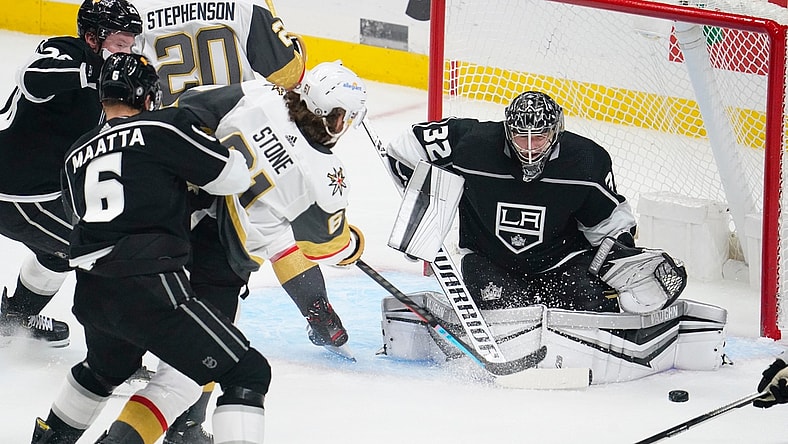 Mar 19, 2021; Los Angeles, California, USA; Vegas Golden Knights right wing Mark Stone (61) takes a shot past Los Angeles Kings defenseman Olli Maatta (6) as Los Angeles Kings goaltender Jonathan Quick (32) defends the goal during the first period at Staples Center. Mandatory Credit: Robert Hanashiro-USA TODAY Sports