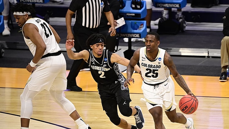 Mar 20, 2021; Indianapolis, Indiana, USA; Colorado Buffaloes guard McKinley Wright IV (25) dribbles against Georgetown Hoyas guard Dante Harris (2) during the first round of the 2021 NCAA Tournament at Hinkle Fieldhouse. Mandatory Credit: Marc Lebryk-USA TODAY Sports