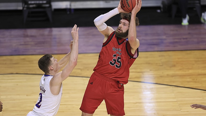 Mar 20, 2021; Indianapolis, IN, USA; Eastern Washington Eagles forward Tanner Groves (35) shoots over Kansas Jayhawks guard Christian Braun (2) during the first round of the 2021 NCAA Tournament at Indiana Farmers Coliseum.  Mandatory Credit: Aaron Doster-USA TODAY Sports