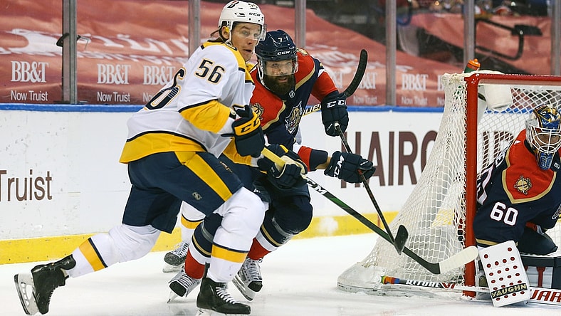 Mar 20, 2021; Sunrise, Florida, USA; Nashville Predators left wing Erik Haula (56) and Florida Panthers defenseman Radko Gudas (7) battle for the puck during the first period at BB&T Center. Mandatory Credit: Sam Navarro-USA TODAY Sports