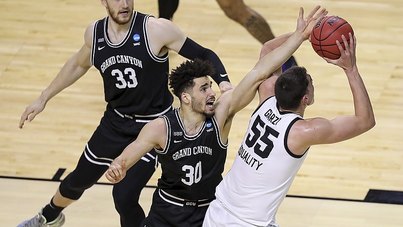 Mar 20, 2021; Indianapolis, IN, USA; Grand Canyon Antelopes center Asbj rn Midtgaard (33) and forward Gabe McGlothan (30) defend against Iowa Hawkeyes center Luka Garza (55) during the first round of the 2021 NCAA Tournament at Indiana Farmers Coliseum.  Mandatory Credit: Katie Stratman-USA TODAY Sports