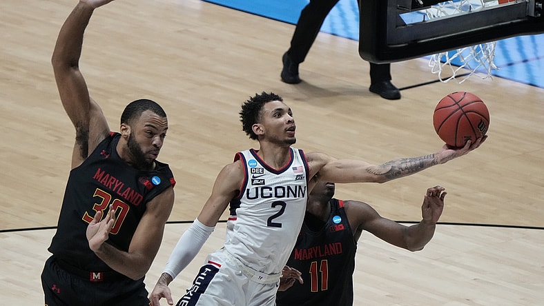 Mar 20, 2021; West Lafayette, Indiana, USA; Connecticut Huskies guard James Bouknight (2) shoots the ball against Maryland Terrapins forward Galin Smith (30) and guard Darryl Morsell (11) during the first half in the first round of the 2021 NCAA Tournament at Mackey Arena. Mandatory Credit: Mike Dinovo-USA TODAY Sports