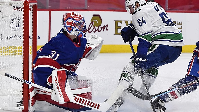 Mar 20, 2021; Montreal, Quebec, CAN; Montreal Canadiens goalie Carey Price (31) stops Vancouver Canucks forward Tyler Motte (64) during the first period at the Bell Centre. Mandatory Credit: Eric Bolte-USA TODAY Sports