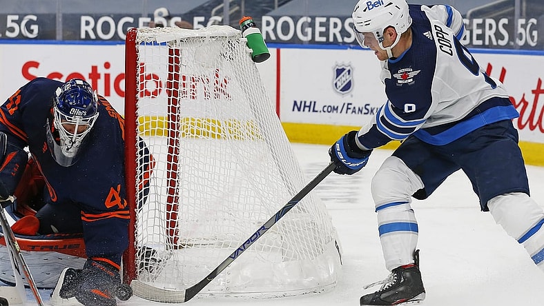 Mar 20, 2021; Edmonton, Alberta, CAN; Edmonton Oilers goaltender Mike Smith (41) makes a save on Winnipeg Jets forward Andrew Copp (9) during the second period at Rogers Place. Mandatory Credit: Perry Nelson-USA TODAY Sports