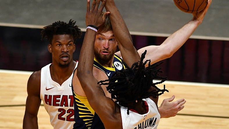 Mar 21, 2021; Miami, Florida, USA; Indiana Pacers forward Domantas Sabonis (11) looks to pass as Miami Heat forward Jimmy Butler (22) and forward Precious Achiuwa (5) defend on the play in the first quarter at American Airlines Arena. Mandatory Credit: Jim Rassol-USA TODAY Sports