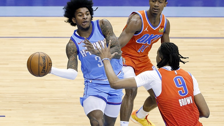 Mar 21, 2021; Houston, TX, USA; Houston Rockets guard Kevin Porter Jr. (3) passes the ball under pressure from Oklahoma City Thunder guard Theo Maledon (11) and Oklahoma City Thunder center Moses Brown (9) during the second half of an NBA basketball game Sunday, March 21, 2021, in Houston. Mandatory Credit: Michael Wyke/Pool Photo-USA TODAY Sports