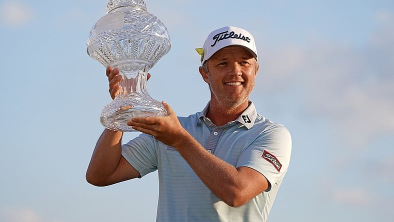 Mar 21, 2021; Palm Beach Gardens, Florida, USA; Matt Jones celebrates with the trophy after winning during The Honda Classic golf tournament. Mandatory Credit: Jasen Vinlove-USA TODAY Sports