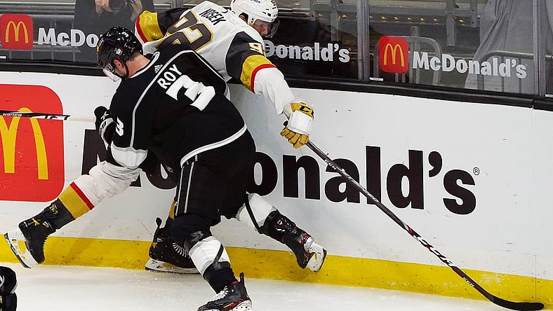 Mar 21, 2021; Los Angeles, California, USA; Vegas Golden Knights left wing Tomas Nosek (92) plays for the puck against Los Angeles Kings defenseman Matt Roy (3) during the third period at Staples Center. Mandatory Credit: Gary A. Vasquez-USA TODAY Sports