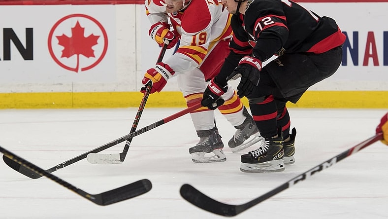 Mar 22, 2021; Ottawa, Ontario, CAN; Calgary Flames left wing Matthew Tkachuk (19) shoots the puck away from Ottawa Senators defenseman Thomas Chabot (72) in the first period at the Canadian Tire Centre. Mandatory Credit: Marc DesRosiers-USA TODAY Sports