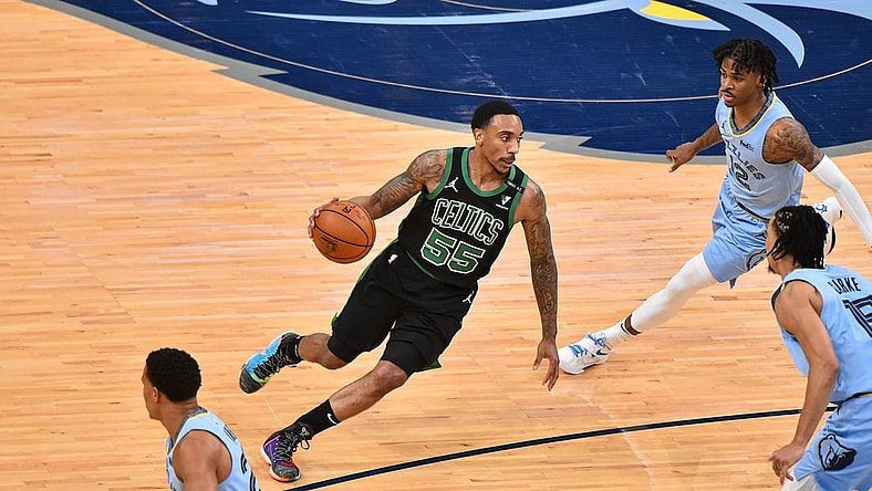 Mar 22, 2021; Memphis, Tennessee, USA; Boston Celtics guard Jeff Teague (55) goes to the basket against Memphis Grizzlies guard Ja Morant (12) during the first half  at FedExForum. Mandatory Credit: Justin Ford-USA TODAY Sports