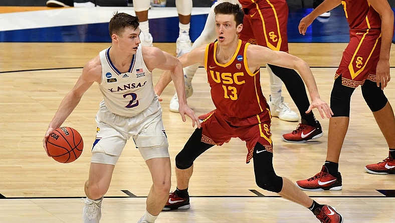 Mar 22, 2021; Indianapolis, Indiana, USA; Kansas Jayhawks guard Christian Braun (2) handles the ball while Southern California Trojans guard Drew Peterson (13) defends during the first half in the second round of the 2021 NCAA Tournament at Hinkle Fieldhouse. Mandatory Credit: Patrick Gorski-USA TODAY Sports