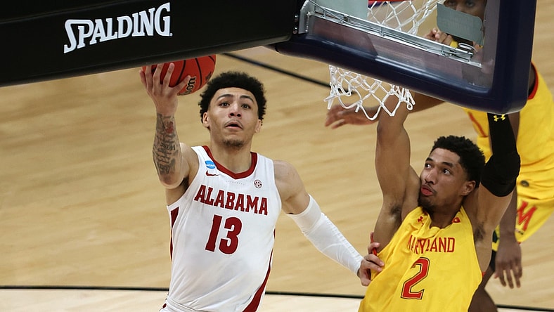 Mar 22, 2021; Indianapolis, Indiana, USA; Alabama Crimson Tide guard Jahvon Quinerly (13) shoots against Maryland Terrapins guard Aaron Wiggins (2) in the second half in the second round of the 2021 NCAA Tournament at Bankers Life Fieldhouse. Mandatory Credit: Trevor Ruszkowski-USA TODAY Sports