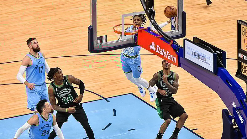Mar 22, 2021; Memphis, Tennessee, USA; Memphis Grizzlies guard Ja Morant (12) dunks against Boston Celtics guard Jeff Teague (55) during the second half at FedExForum. Mandatory Credit: Justin Ford-USA TODAY Sports