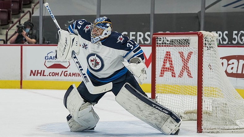 Mar 22, 2021; Vancouver, British Columbia, CAN; Winnipeg Jets goalie Connor Hellebuyck (37) makes a save against the Vancouver Canucks  in the first period at Rogers Arena. Mandatory Credit: Bob Frid-USA TODAY Sports