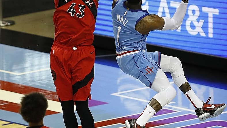 Mar 22, 2021; Houston, Texas, USA; Houston Rockets guard John Wall (1) drives against Toronto Raptors forward Pascal Siakam (43) for a layup during the second quarter at Toyota Center. Mandatory Credit: Bob Levey /POOL PHOTOS-USA TODAY Sports