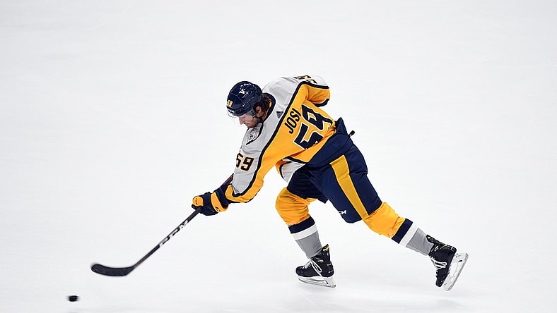 Mar 23, 2021; Nashville, Tennessee, USA; Nashville Predators defenseman Roman Josi (59) shoots the puck during warmups before the game against the Detroit Red Wings at Bridgestone Arena. Mandatory Credit: Christopher Hanewinckel-USA TODAY Sports
