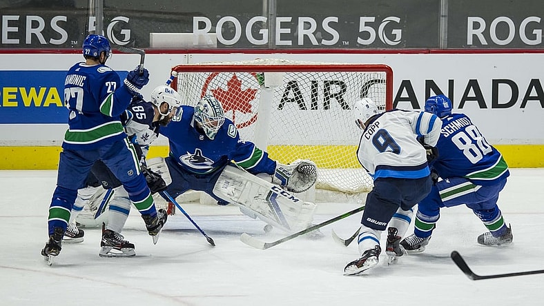 Mar 24, 2021; Vancouver, British Columbia, CAN;  Winnipeg Jets forward Andrew Copp (9) scores a goal on Vancouver Canucks goalie Thatcher Demko (35) in the second period at Rogers Arena. Mandatory Credit: Bob Frid-USA TODAY Sports