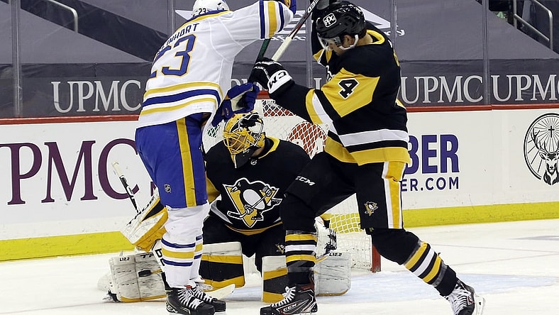 Mar 25, 2021; Pittsburgh, Pennsylvania, USA; Pittsburgh Penguins goaltender Casey DeSmith (1) makes a save as Pens defenseman Cody Ceci (4) battles Buffalo Sabres center Sam Reinhart (23) during the first period at PPG Paints Arena. Mandatory Credit: Charles LeClaire-USA TODAY Sports