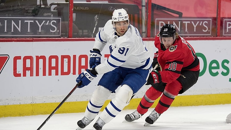 Mar 25, 2021; Ottawa, Ontario, CAN; Toronto Maple Leafs center John Tavares (91) skates with the puck in front of  Ottawa Senators left wing Ryan Dzingel (10) in the first period at the Canadian Tire Centre. Mandatory Credit: Marc DesRosiers-USA TODAY Sports