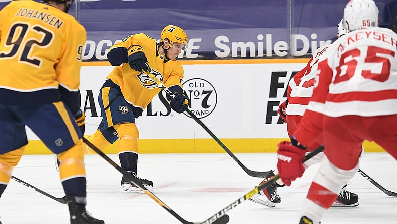 Mar 25, 2021; Nashville, Tennessee, USA; Nashville Predators right wing Eeli Tolvanen (28) scores on the power play during the first period against the Detroit Red Wings at Bridgestone Arena. Mandatory Credit: Christopher Hanewinckel-USA TODAY Sports