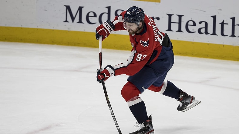 Mar 25, 2021; Washington, District of Columbia, USA; Washington Capitals center Evgeny Kuznetsov (92) shoots the puck against the New Jersey Devils during the third period at Capital One Arena. Mandatory Credit: Scott Taetsch-USA TODAY Sports