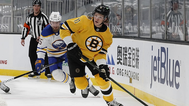 Mar 27, 2021; Boston, Massachusetts, USA; Boston Bruins center Trent Frederic (11) looks to pass as Buffalo Sabres defenseman Rasmus Ristolainen (55) looks on during the first period at TD Garden. Mandatory Credit: Winslow Townson-USA TODAY Sports