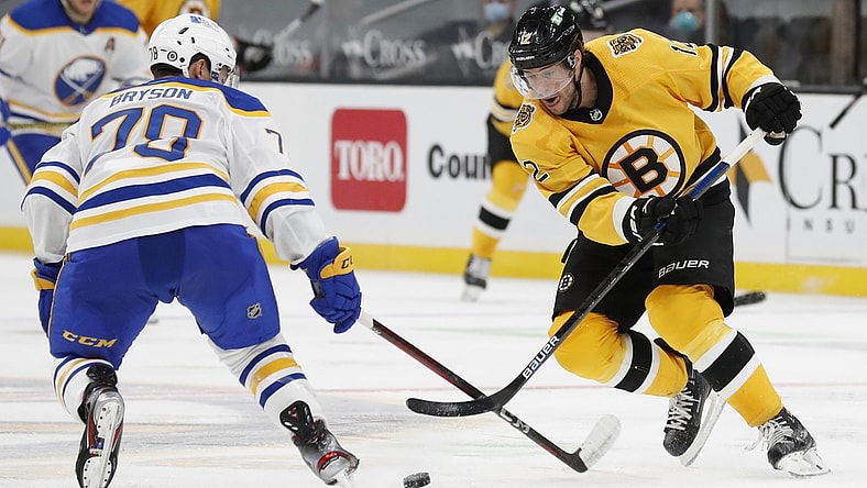 Mar 27, 2021; Boston, Massachusetts, USA; Boston Bruins right wing Craig Smith (12) tries to get past Buffalo Sabres defenseman Jacob Bryson (78) during the third period at TD Garden. Mandatory Credit: Winslow Townson-USA TODAY Sports