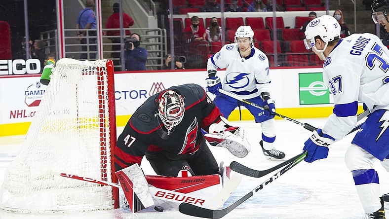 Mar 27, 2021; Raleigh, North Carolina, USA;  Carolina Hurricanes goaltender James Reimer (47) stops Tampa Bay Lightning center Yanni Gourde (37) shot during the first period at PNC Arena. Mandatory Credit: James Guillory-USA TODAY Sports