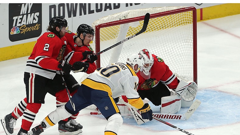 Mar 27, 2021; Chicago, Illinois, USA; Nashville Predators center Colton Sissons (10) moves in on Chicago Blackhawks goaltender Kevin Lankinen (32) during the second period at the United Center. Mandatory Credit: Dennis Wierzbicki-USA TODAY Sports